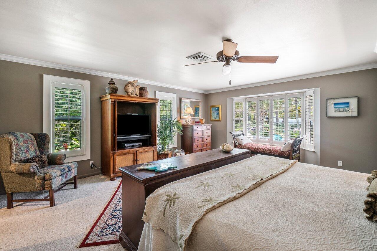 33 Ocean Drive Jupiter Inlet Colony, FL 33469 - Photo 21 of 30 a bedroom with a bed and large windows