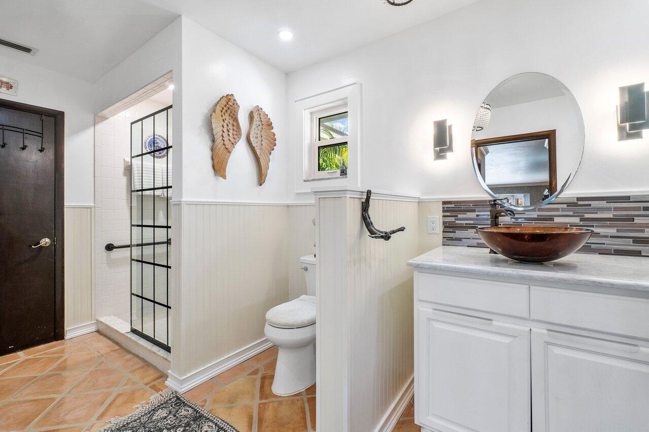 33 Ocean Drive Jupiter Inlet Colony, FL 33469 - Photo 22 of 30 a bathroom with a toilet a sink and mirror