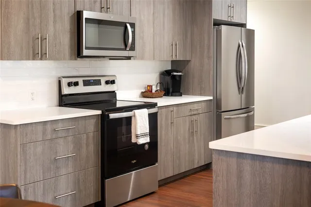 a kitchen with a sink stove and refrigerator