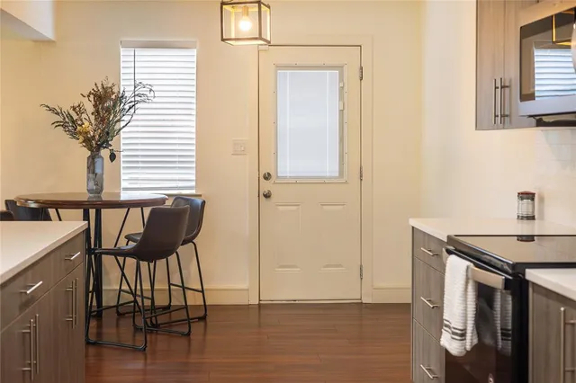 a view of a kitchen with a table and chairs