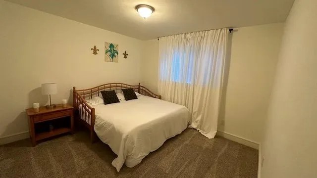 a bedroom with a bed and table