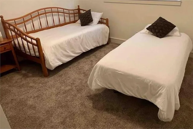 a bedroom with a bed and a table
