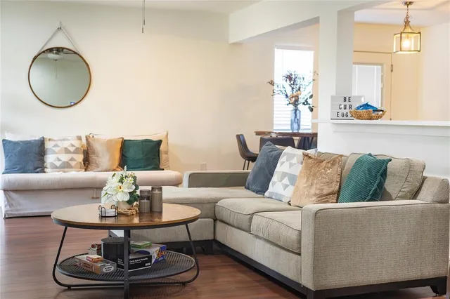a living room with furniture a rug and a window