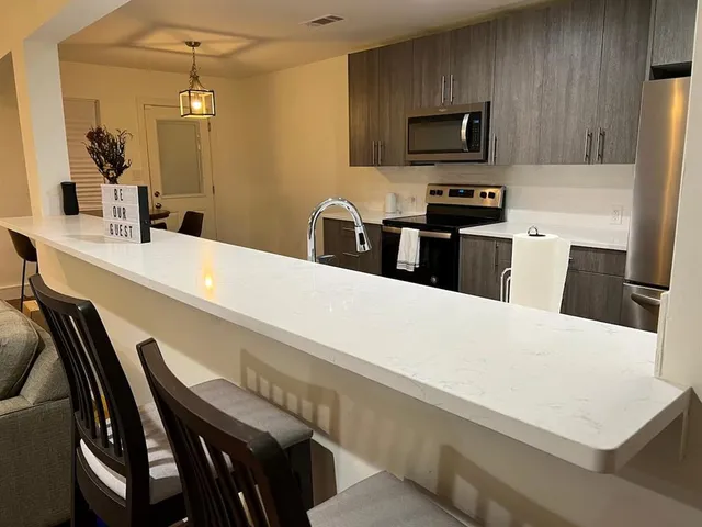 a kitchen with a table and chairs