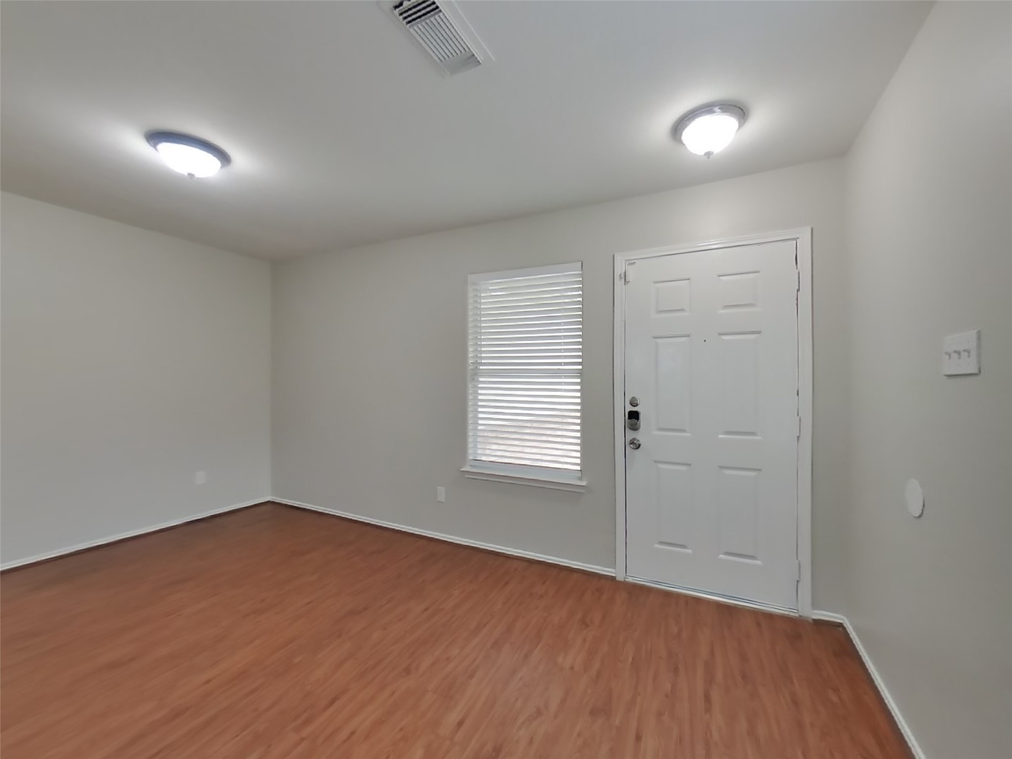 8227 Radial Court Rosharon, TX 77583 - Photo 12 of 16 an empty room with wooden floor and windows