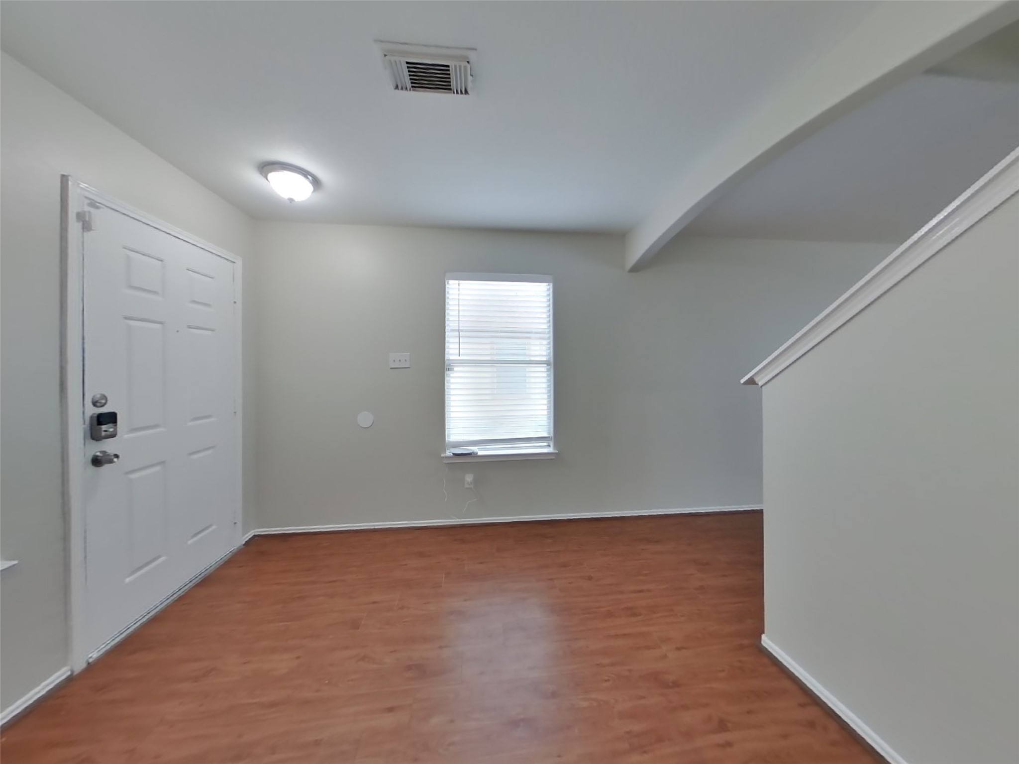 8227 Radial Court Rosharon, TX 77583 - Photo 13 of 16 wooden floor in an empty room with a window