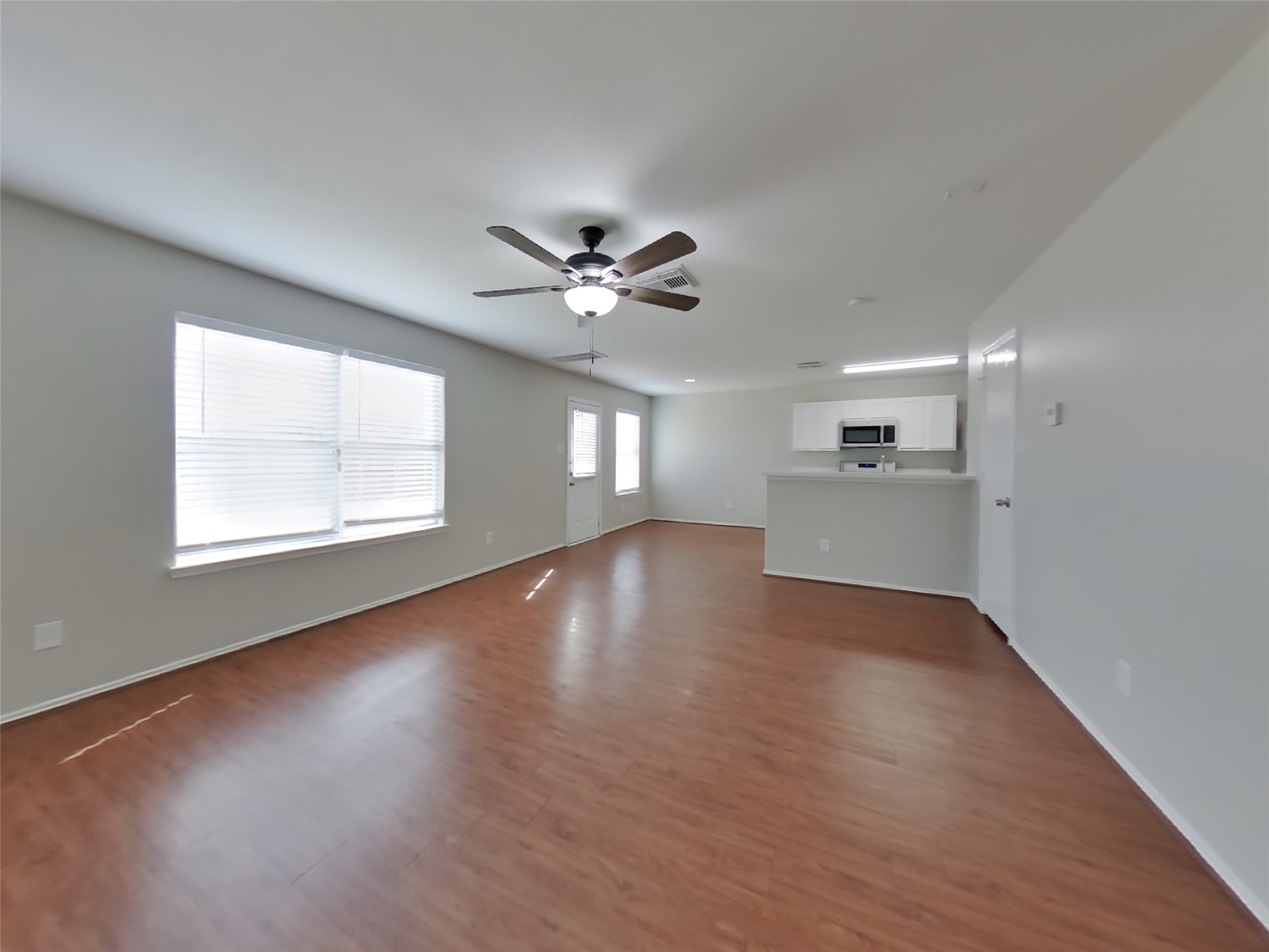 8227 Radial Court Rosharon, TX 77583 - Photo 3 of 16 a view of an empty room with a window and wooden floor