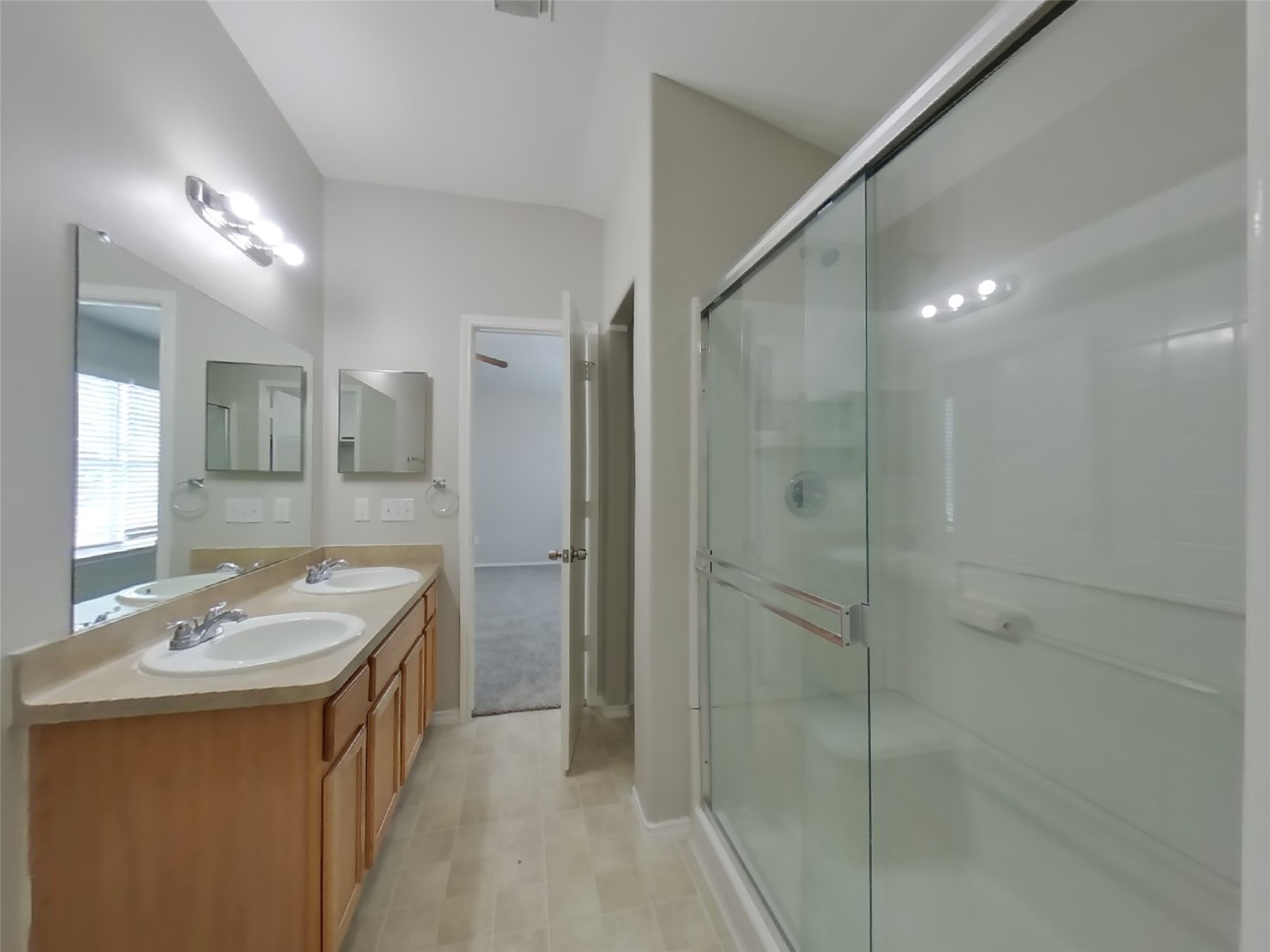 8227 Radial Court Rosharon, TX 77583 - Photo 6 of 16 a bathroom with a granite countertop sink a mirror and a shower
