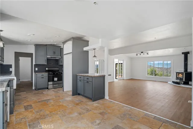 a large kitchen with cabinets and stainless steel appliances
