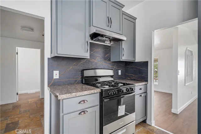 a kitchen with granite countertop cabinets and steel stainless steel appliances