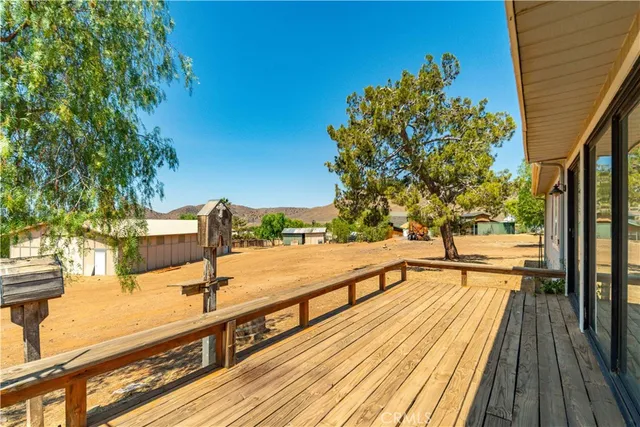 a view of balcony with wooden floor and seating space