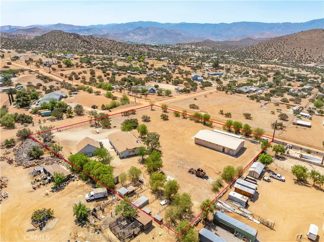 an aerial view of residential house and sandy dunes