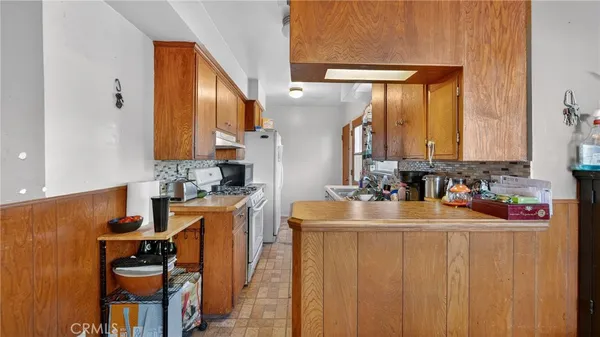 a kitchen with stainless steel appliances a sink stove and cabinets