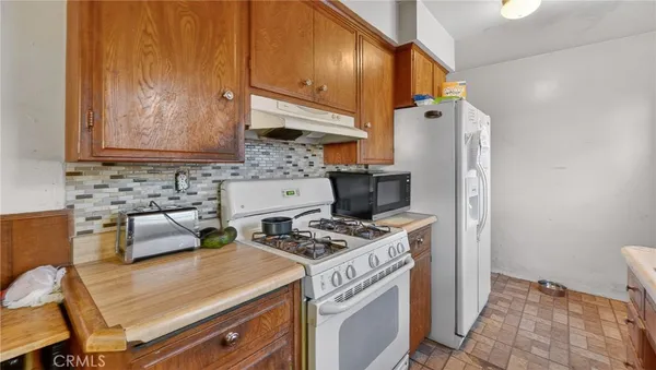 a kitchen with a stove and a refrigerator