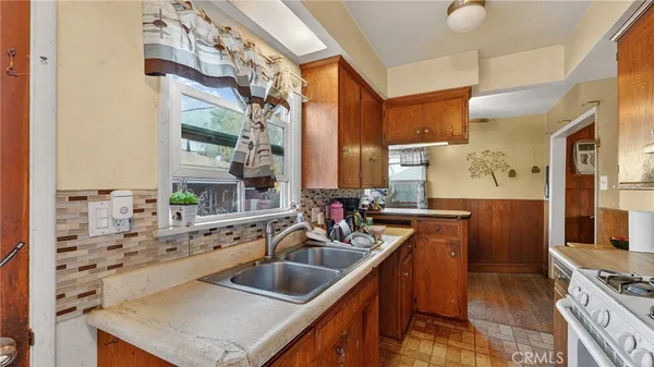 a kitchen with stainless steel appliances sink a stove and a microwave