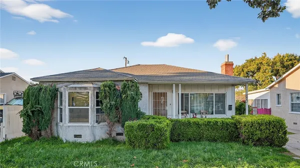 a view of a house with a yard and plants