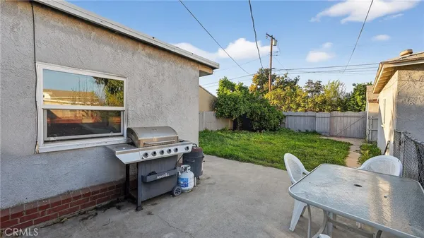 a backyard of a house with a table and chairs