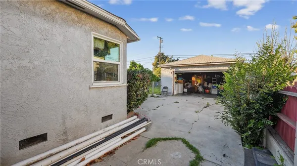an outdoor view of a house with a backyard