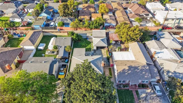 an aerial view of multiple houses with yard