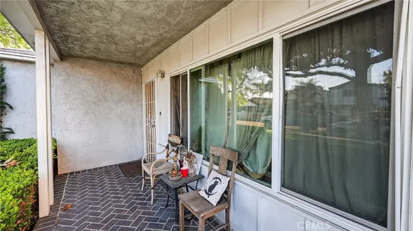 a view of a balcony with chair and table