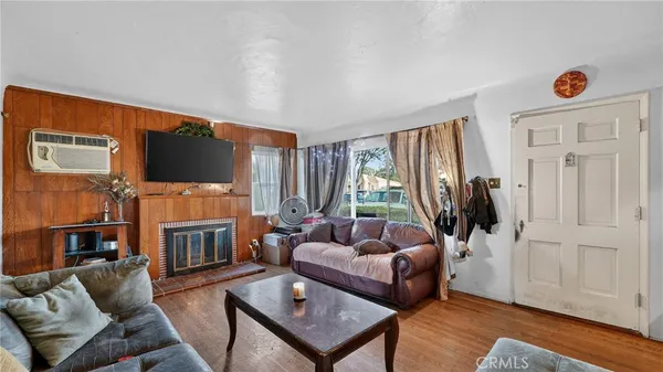 a living room with furniture flat screen tv and a fireplace