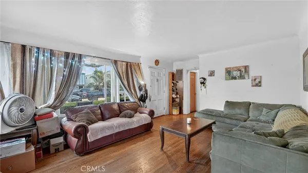 a living room with furniture a table and a large window
