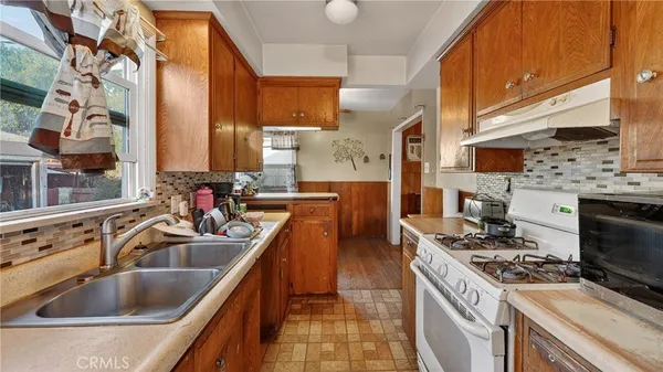 a kitchen that has a sink and a stove