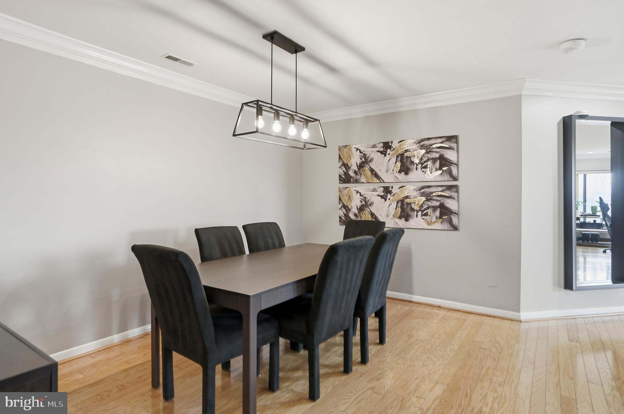 3021 Fallstaff Road, Unit 502B Baltimore, MD 21209 - Photo 10 of 39 a view of a dining room with furniture wooden floor and a chandelier