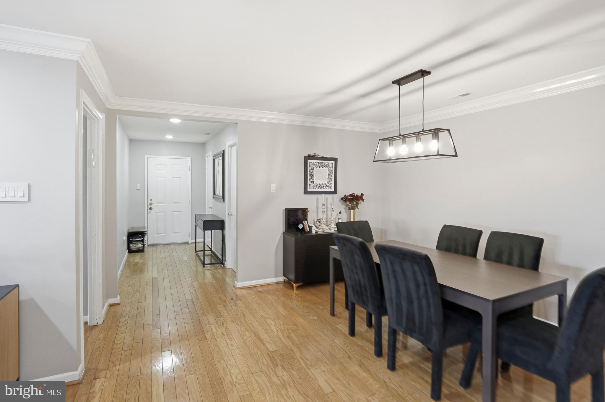 3021 Fallstaff Road, Unit 502B Baltimore, MD 21209 - Photo 11 of 39 a view of a dining room with furniture and wooden floor