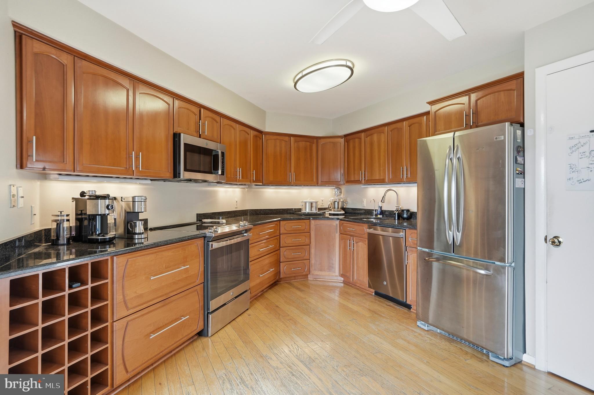 3021 Fallstaff Road, Unit 502B Baltimore, MD 21209 - Photo 12 of 39 a kitchen with stainless steel appliances granite countertop a refrigerator stove top oven and sink