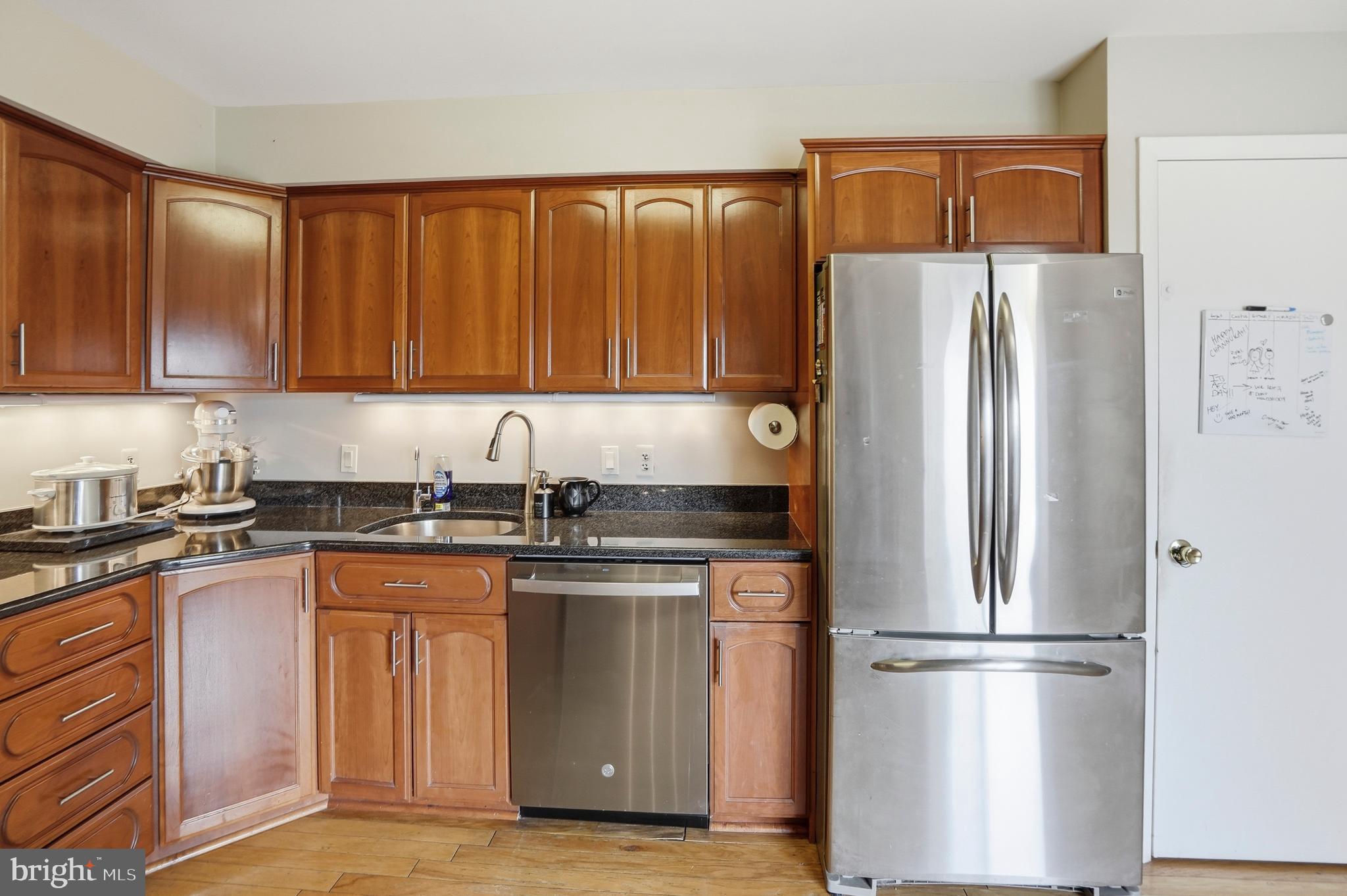 3021 Fallstaff Road, Unit 502B Baltimore, MD 21209 - Photo 13 of 39 a kitchen with a refrigerator sink and cabinets
