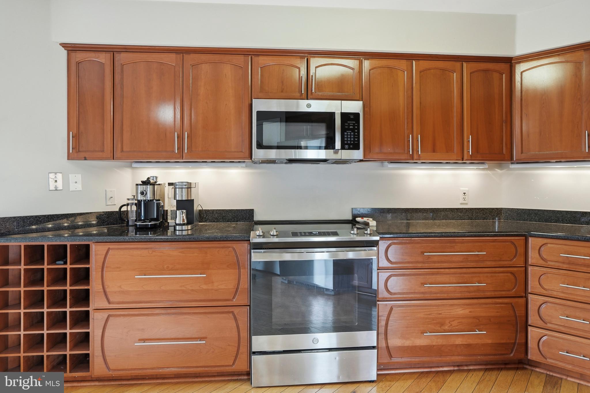 3021 Fallstaff Road, Unit 502B Baltimore, MD 21209 - Photo 14 of 39 a kitchen with stainless steel appliances granite countertop a stove and a microwave