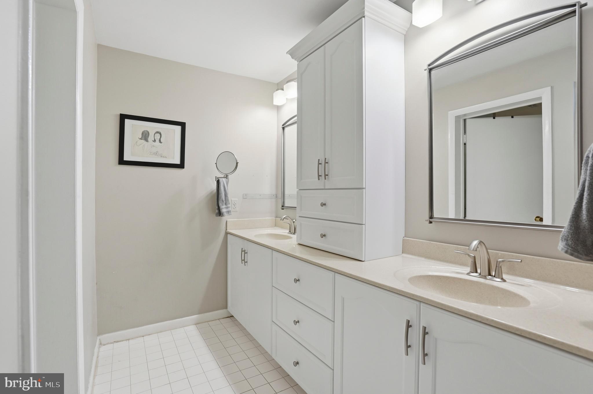 3021 Fallstaff Road, Unit 502B Baltimore, MD 21209 - Photo 19 of 39 a bathroom with 2 sink and a mirror