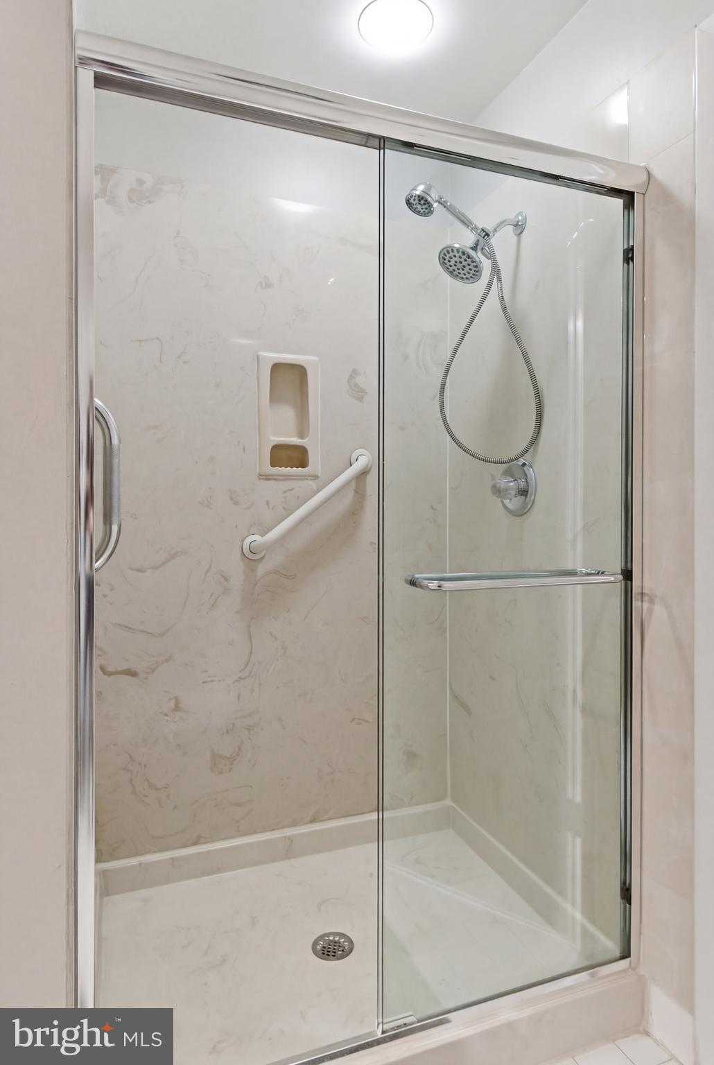 3021 Fallstaff Road, Unit 502B Baltimore, MD 21209 - Photo 20 of 39 a bathroom with a glass shower door