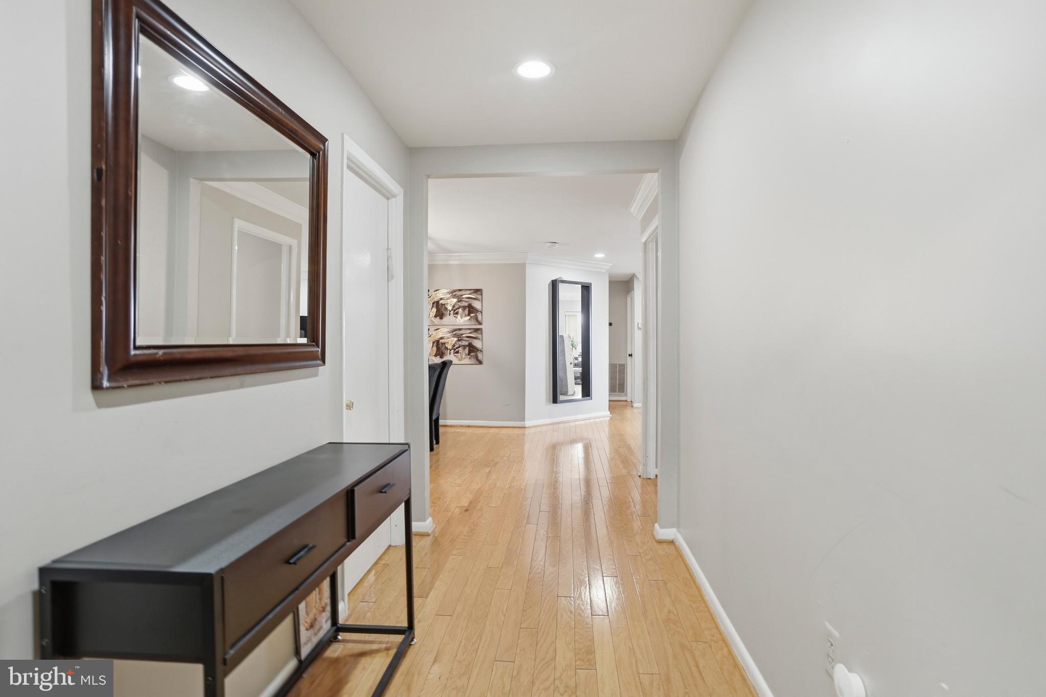 3021 Fallstaff Road, Unit 502B Baltimore, MD 21209 - Photo 3 of 39 a hallway with wooden floor table and windows