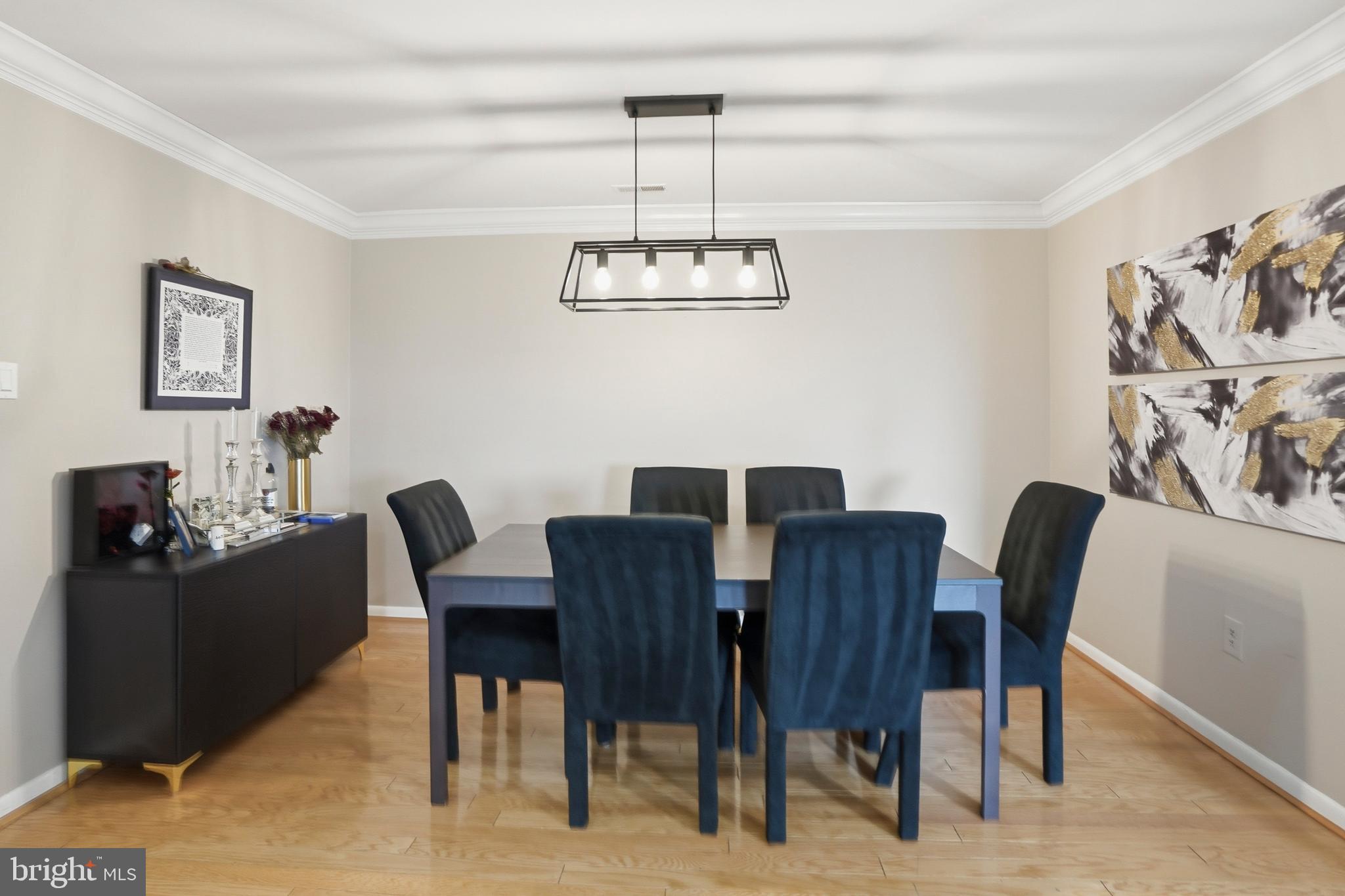 3021 Fallstaff Road, Unit 502B Baltimore, MD 21209 - Photo 9 of 39 a view of a dining room with furniture wooden floor and a chandelier