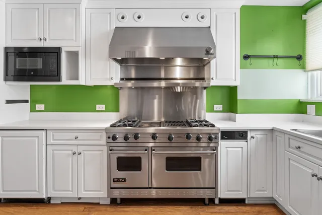 a bathroom with a bathtub shower sink and mirror