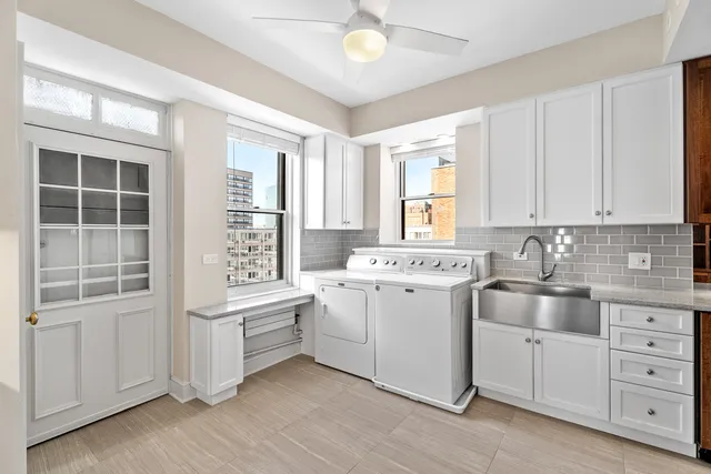 a kitchen with stainless steel appliances granite countertop a sink and dishwasher a stove top oven with wooden floor