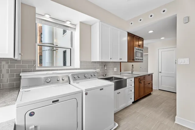 a kitchen with granite countertop a sink a stove and cabinets