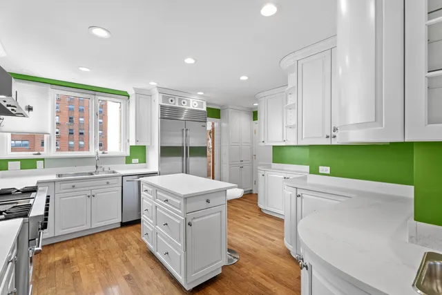 a kitchen with a stove sink and cabinets