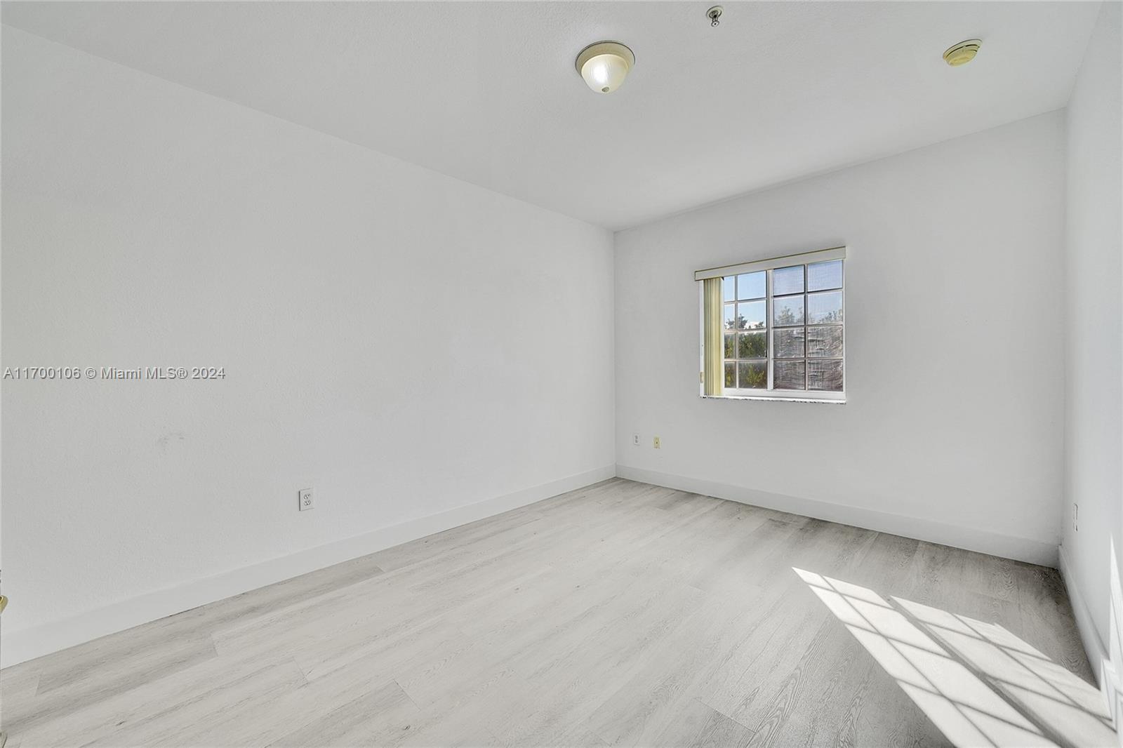 6940 Northwest 179th Street, Unit 3057 Hialeah, FL 33015 - Photo 12 of 32 an empty room with a window