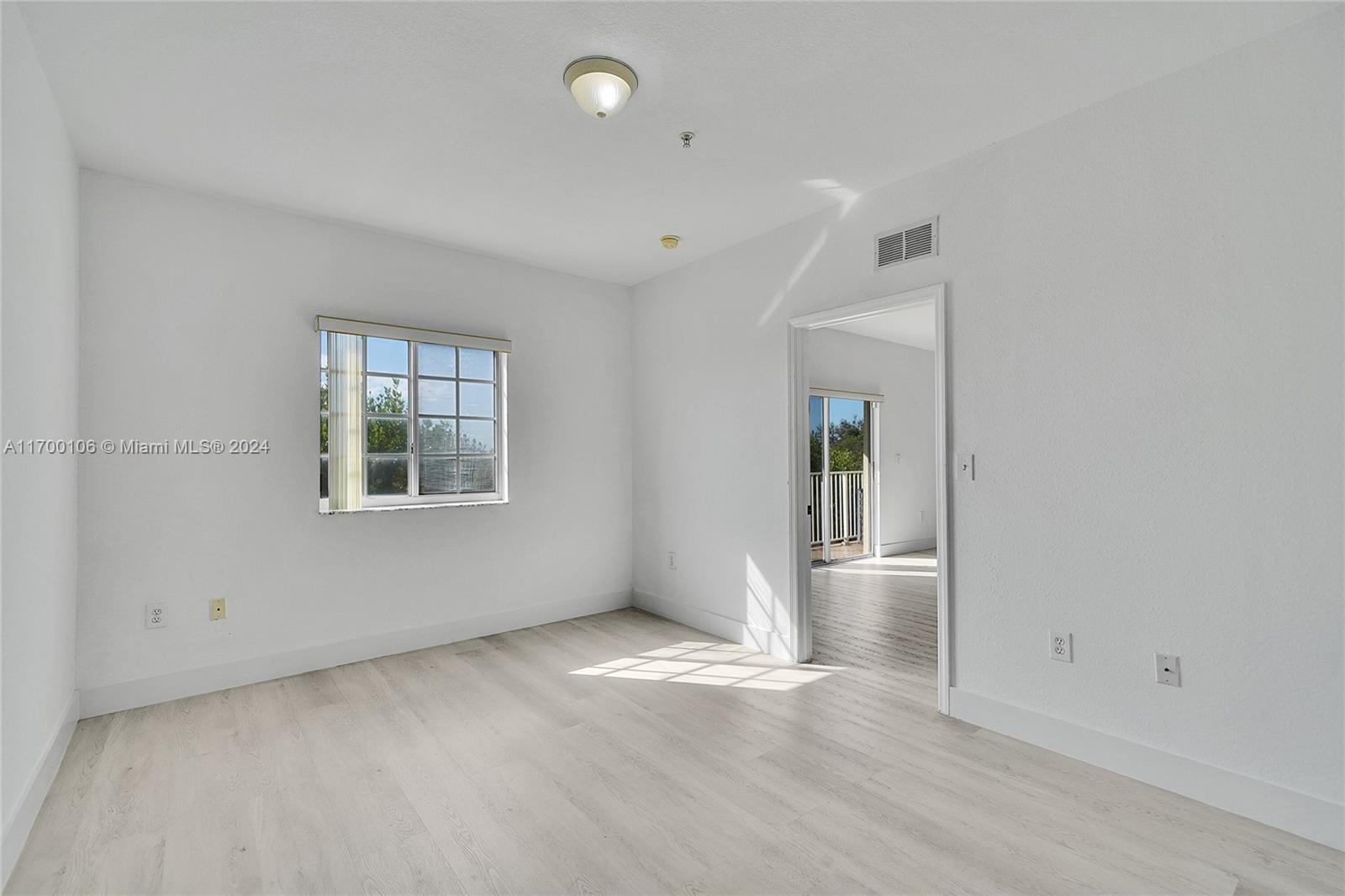 6940 Northwest 179th Street, Unit 3057 Hialeah, FL 33015 - Photo 13 of 32 an empty room with windows