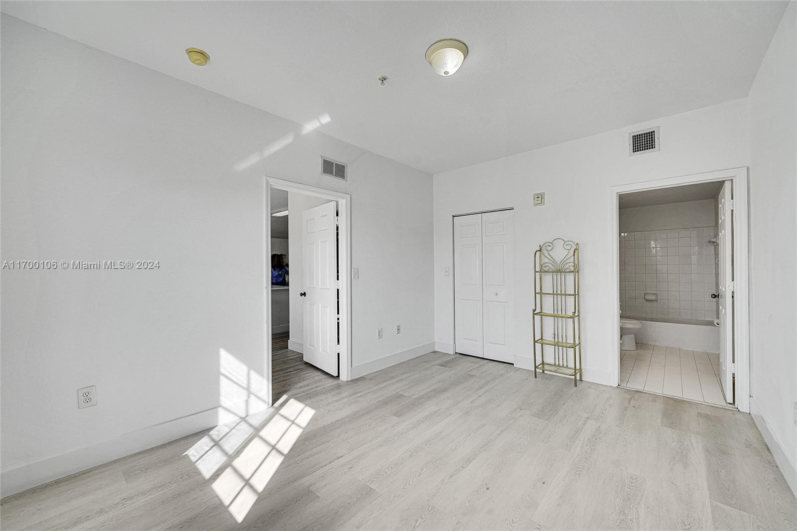 6940 Northwest 179th Street, Unit 3057 Hialeah, FL 33015 - Photo 14 of 32 wooden floor in an empty room with a window