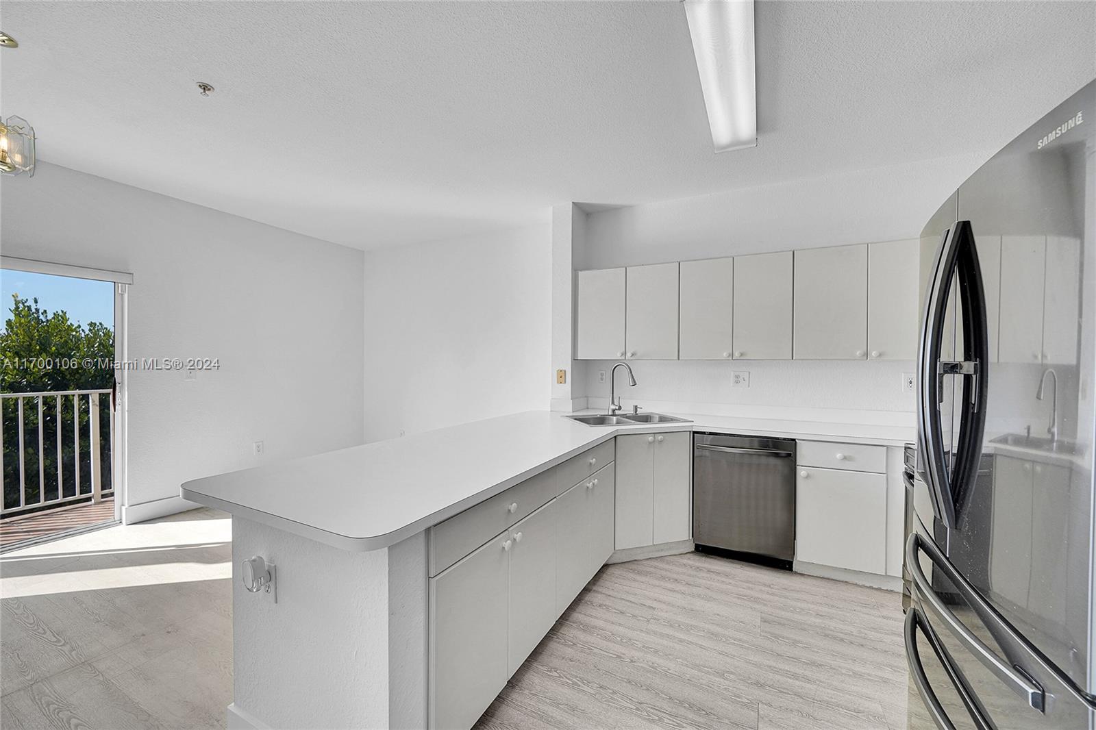 6940 Northwest 179th Street, Unit 3057 Hialeah, FL 33015 - Photo 20 of 32 a kitchen with white cabinets appliances and sink