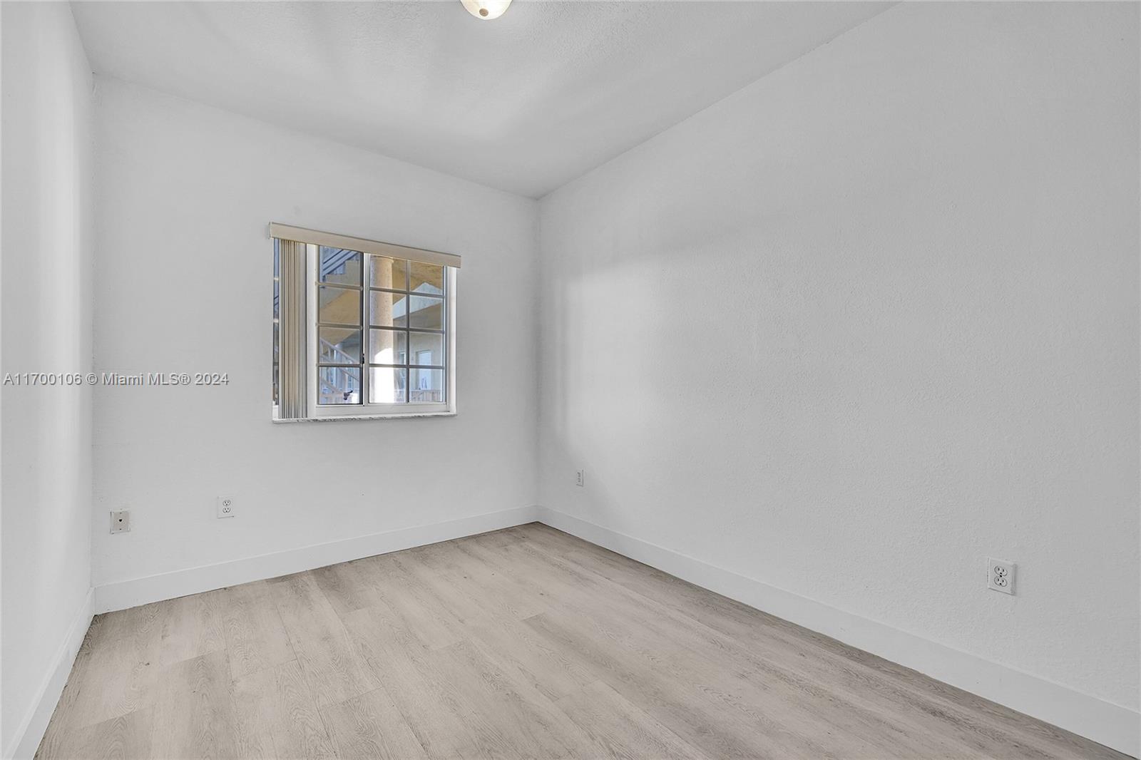 6940 Northwest 179th Street, Unit 3057 Hialeah, FL 33015 - Photo 23 of 32 an empty room with a window