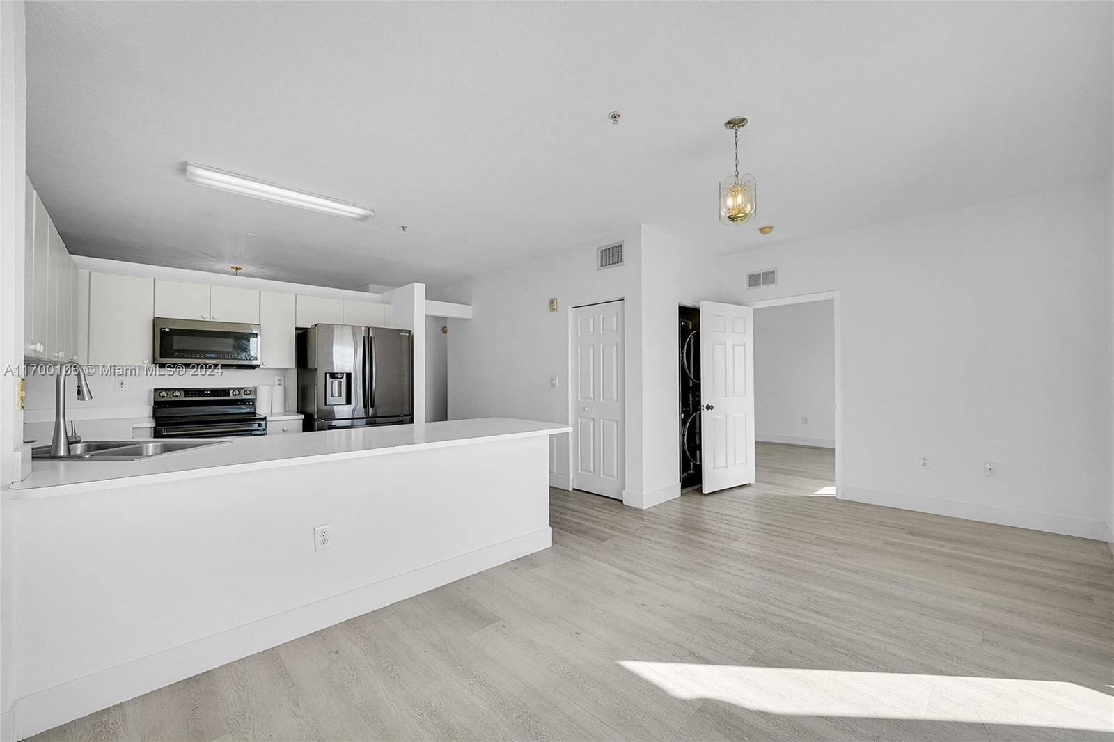 6940 Northwest 179th Street, Unit 3057 Hialeah, FL 33015 - Photo 6 of 32 a view of a kitchen with stainless steel appliances a refrigerator