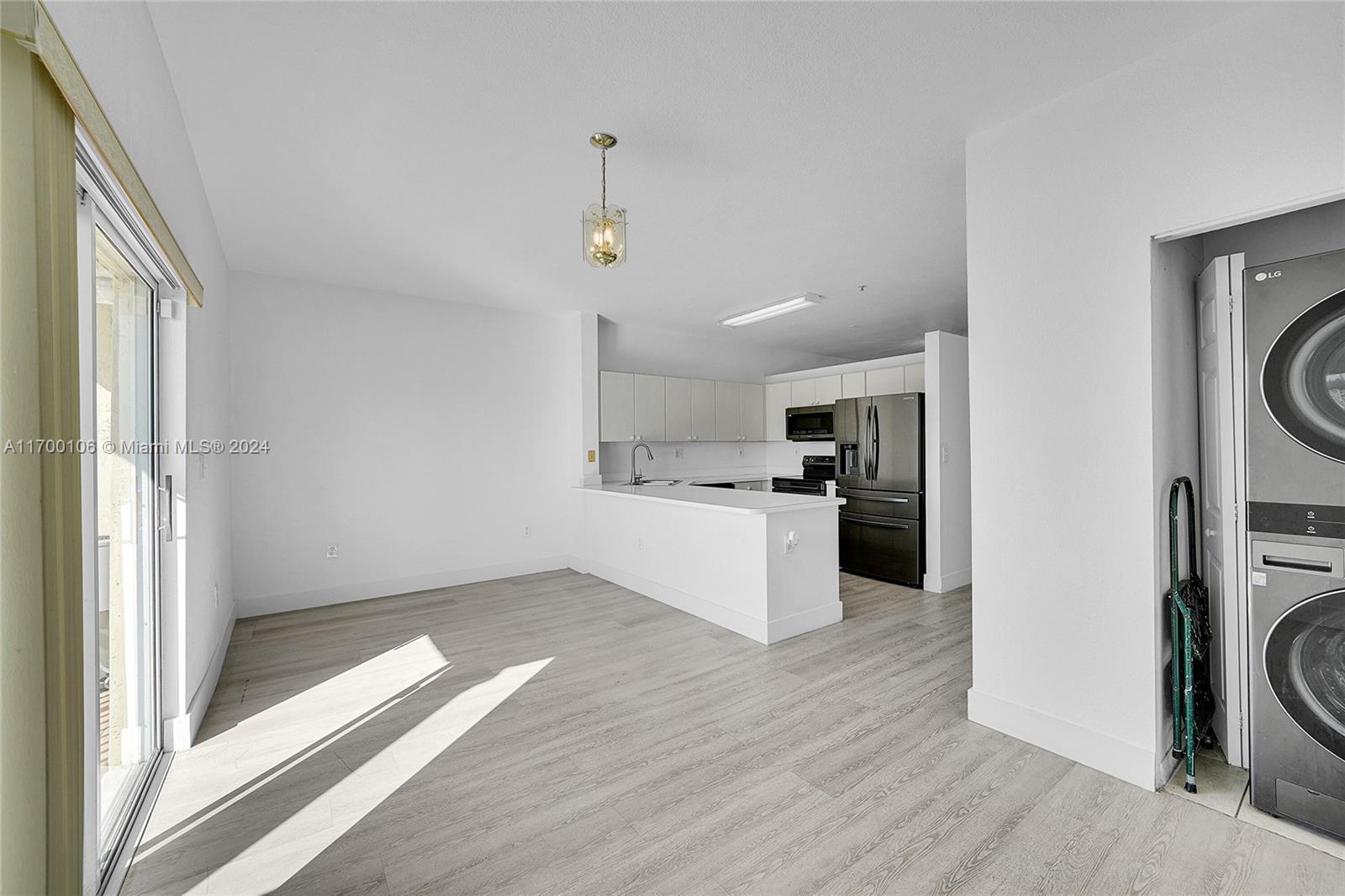 6940 Northwest 179th Street, Unit 3057 Hialeah, FL 33015 - Photo 8 of 32 a view of a kitchen with a sink a refrigerator and window