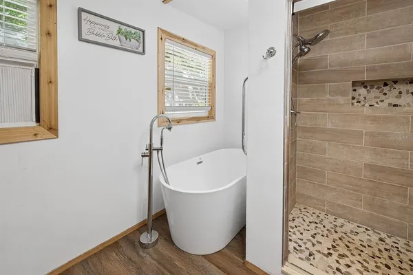 a bathroom with a bathtub and shower