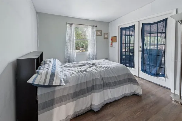 a bedroom with a bed and large window
