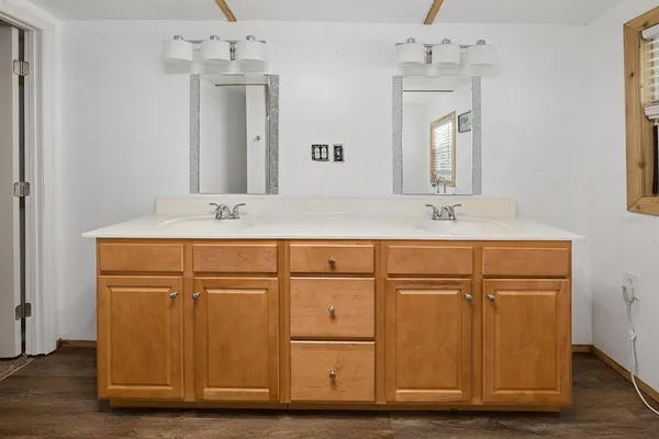 a bathroom with a sink mirror and cabinets